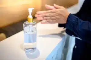 Man using hand sanitizer. COVID Antigen test